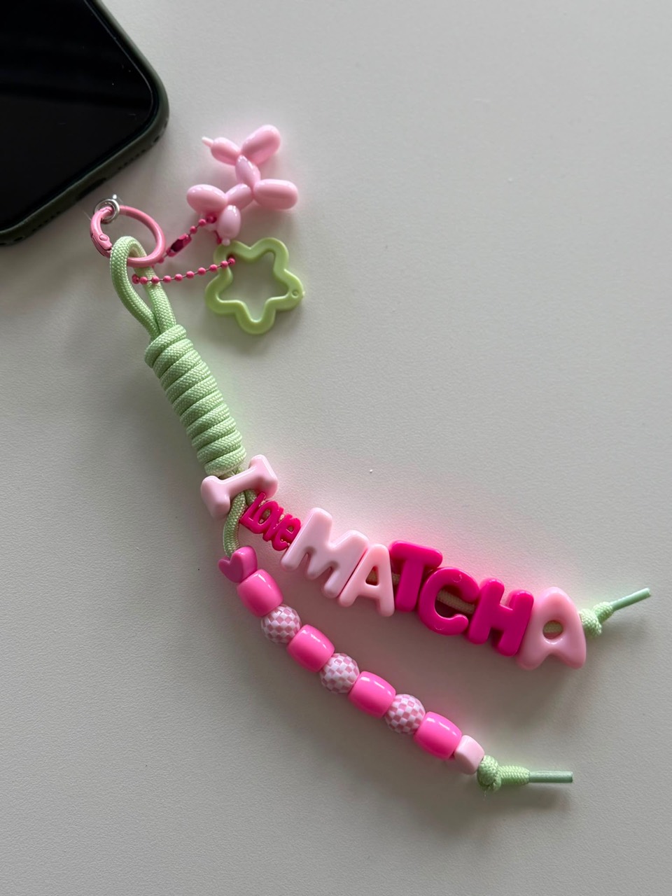 Pastel green and pink Love Matcha charm with balloon dog and star details